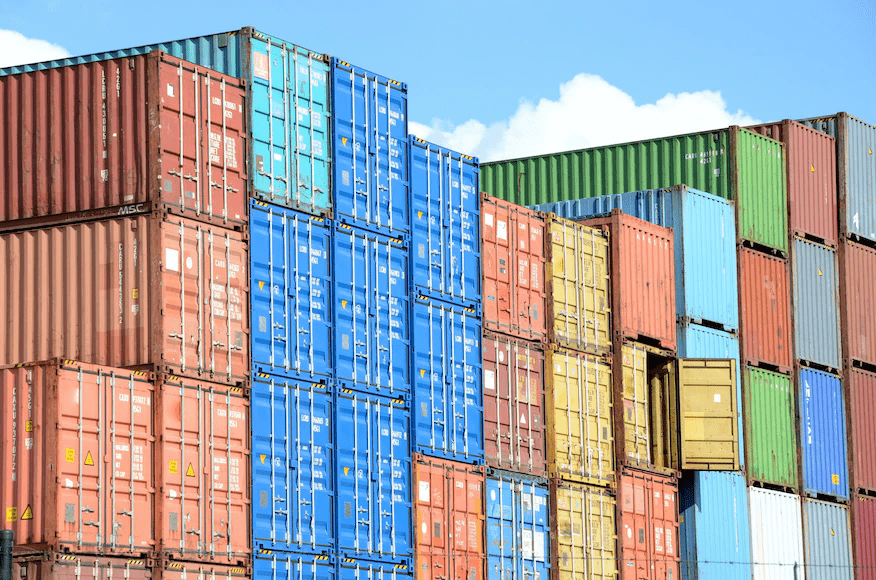 Many shipping containers stacked on top of each other